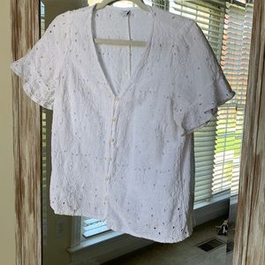 White eyelet button up blouse.